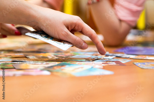 A woman's hand sorts out sorting pictures