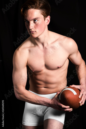 Rugby player in studio prepared to throw ball © pavelgulea