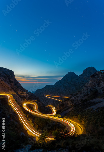 long exposure road at night between mountains
