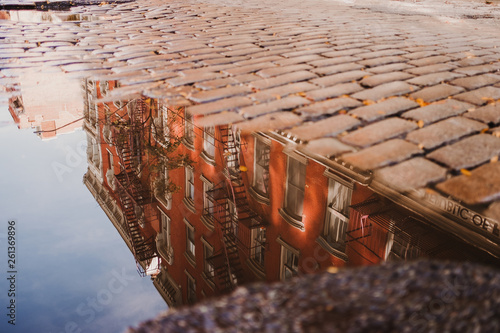 Puddle reflecting buildings, New York, USA