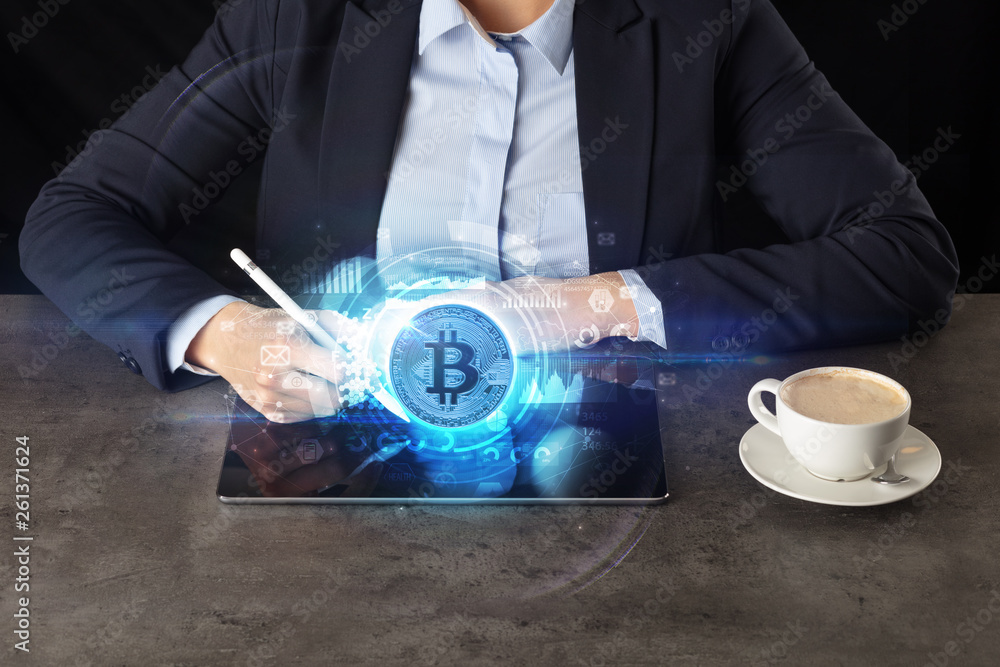 Business woman working on tablet with cryptocurrency and network concept
