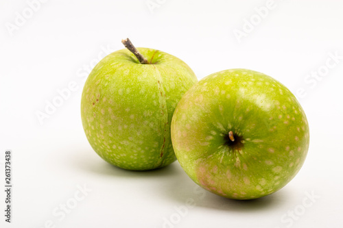 Two green ripe apple close up on a white background
