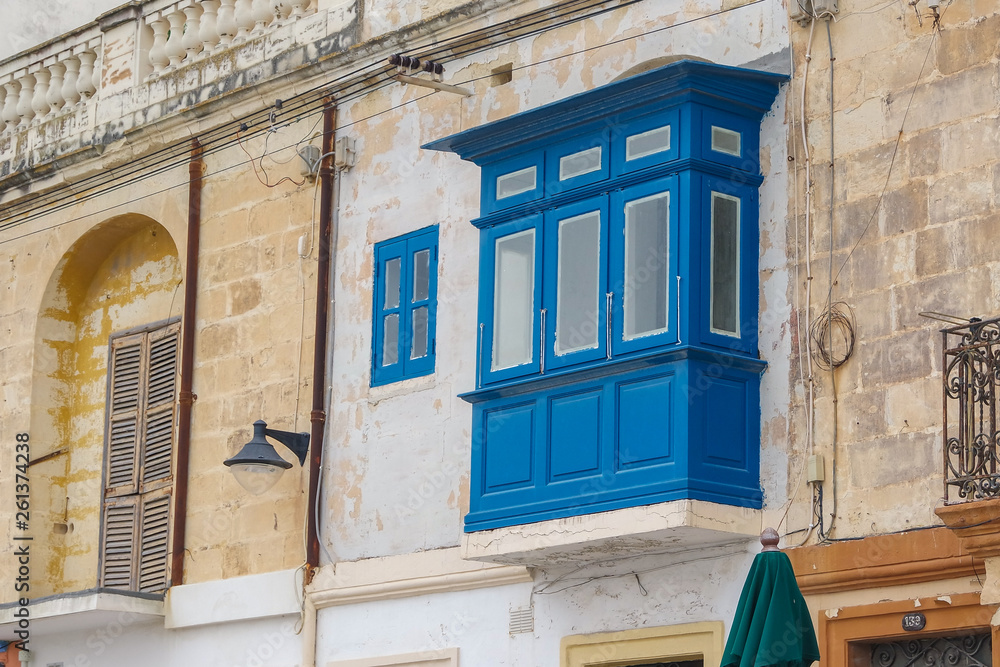 Old balcony and apartment buildings in Marsaxlokk, Malta