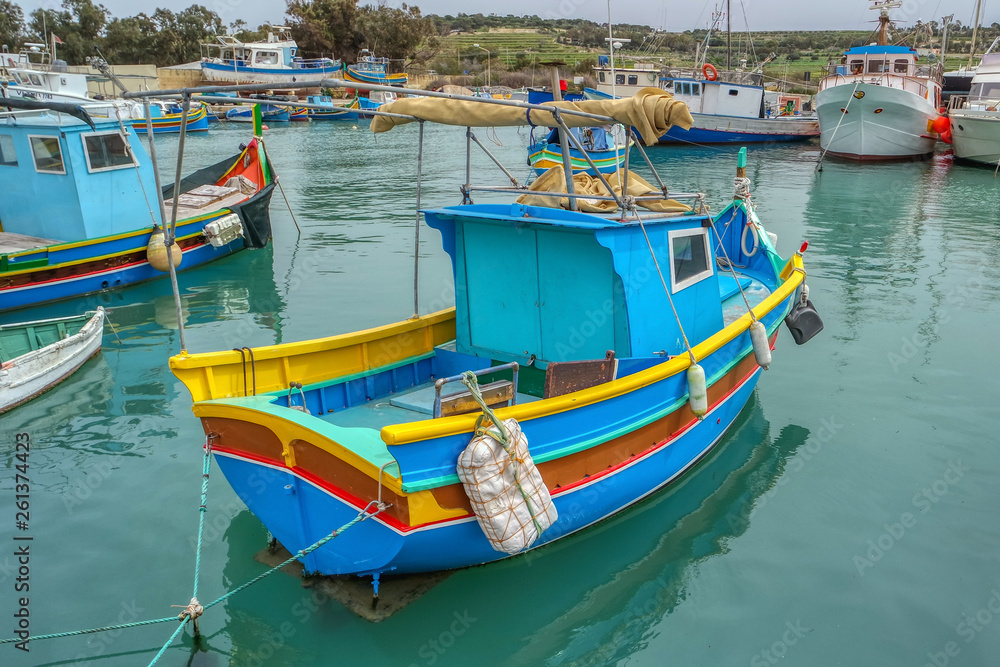 Colorful fishing boats moor in Marsaxlokk, Malta