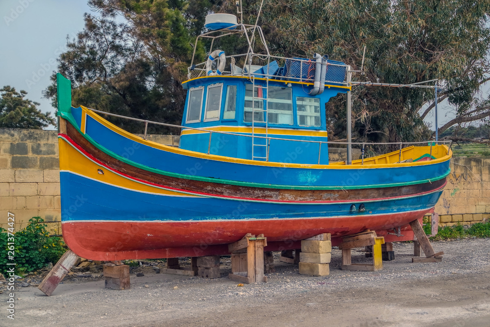 Traditional eyed colorful boats Luzzu in the Harbor of fishing village Marsaxlokk, Malta