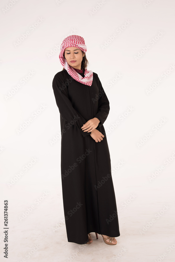 Young Arab female in traditional dress on white background