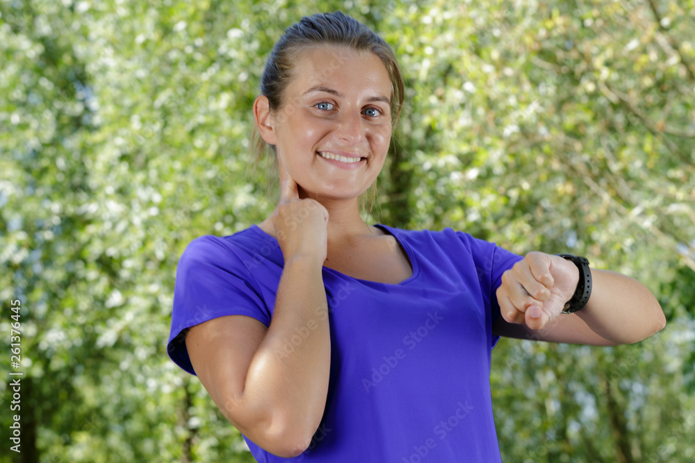 young woman checking watch after workout young woman checking watch after workout