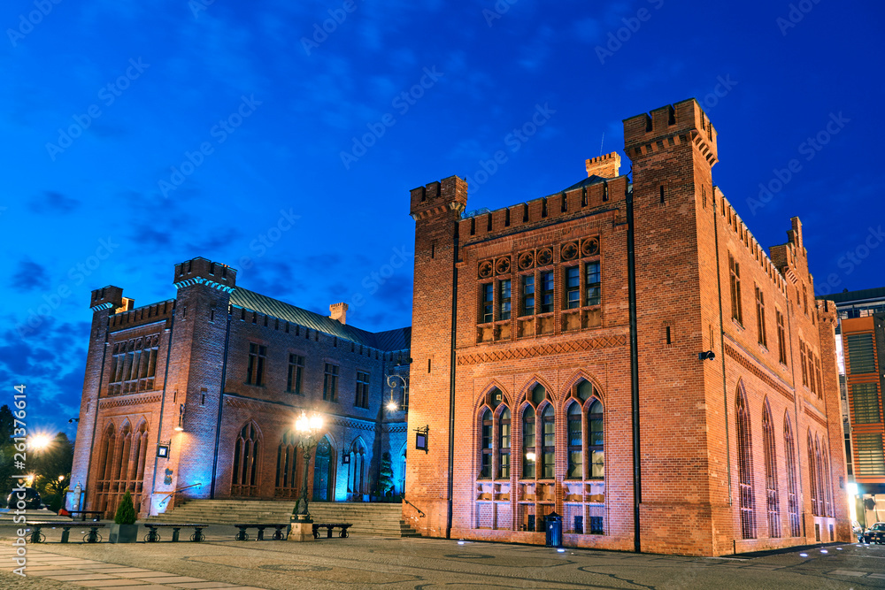 Fototapeta premium Neo-Gothic, historic building of the red brick town hall during the night in Kolobrzeg..