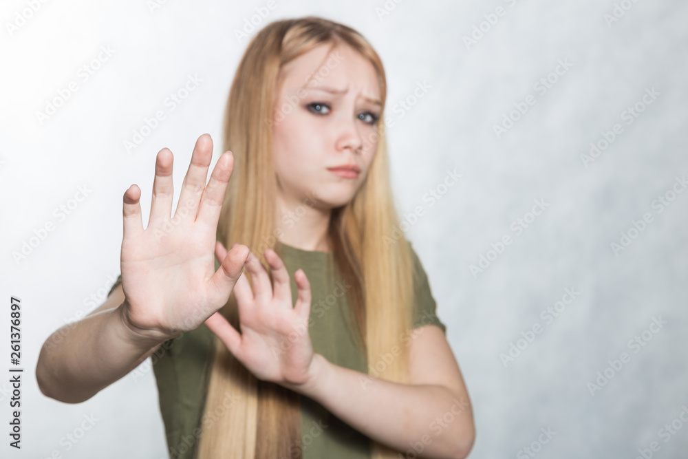 Young sad woman raising palms in no or stop gesture, wanting to decline offer. Young sad woman raising palms in no or stop gesture, wanting to decline offer.