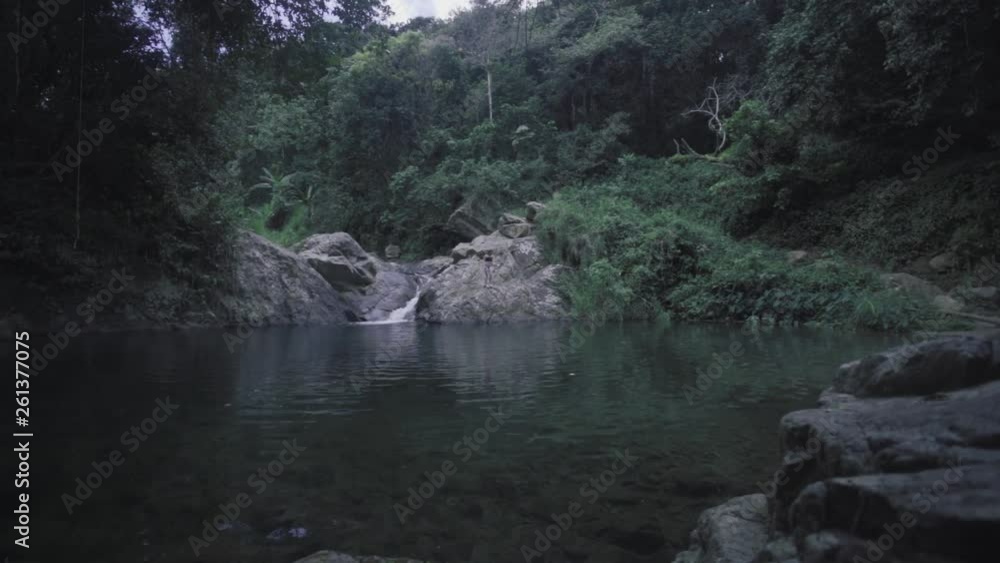 SLOW MOTION: looking over the water towards Mango Waterfall in Adjuntas, Puerto Rico SLOW MOTION: looking over the water towards Mango Waterfall in Adjuntas, Puerto Rico