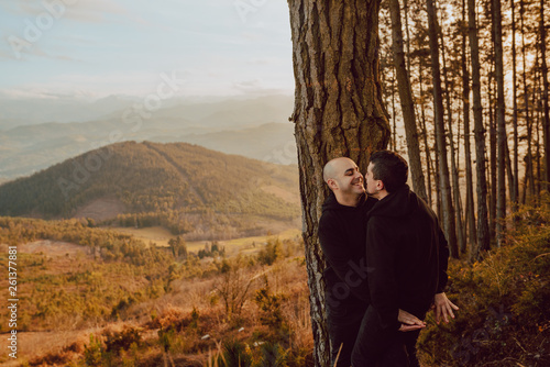 Boyfriends embracing in woods photo