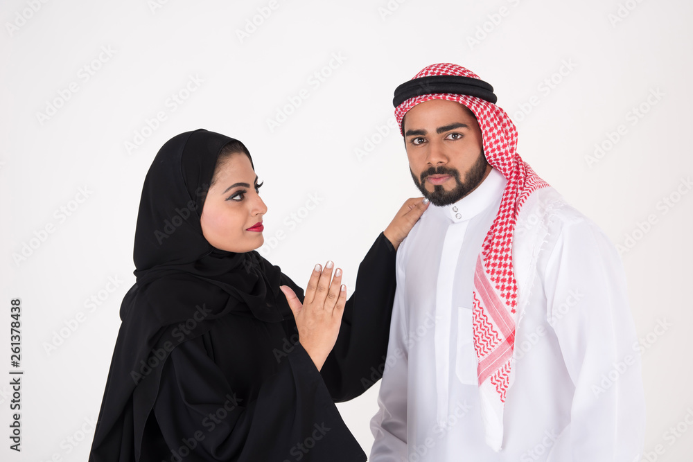 Arab Couple in traditional dress fighting on white background