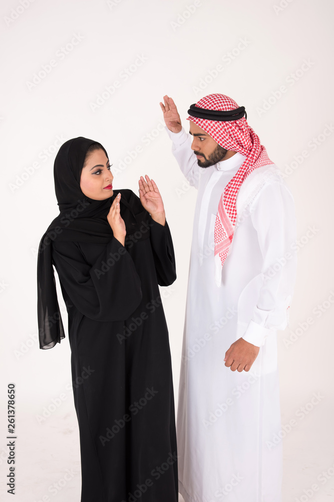 Arab Couple in traditional dress fighting on white background