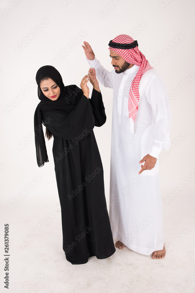 Arab Couple in traditional dress fighting on white background