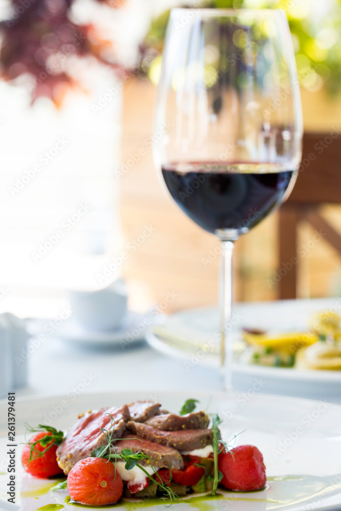 Grilled beef with cherry and mozzarella. Restaurant and red wine. Grilled beef with cherry and mozzarella. Restaurant and red wine.