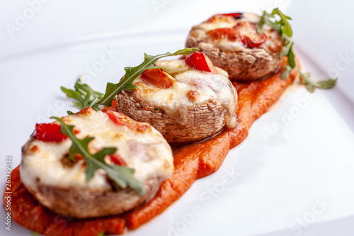 Stuffed mushrooms with parmesan crust and fresh herbs.