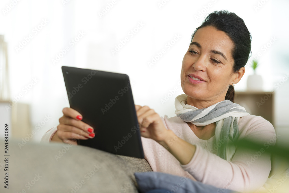 beautiful woman at home working with a tablet beautiful woman at home working with a tablet