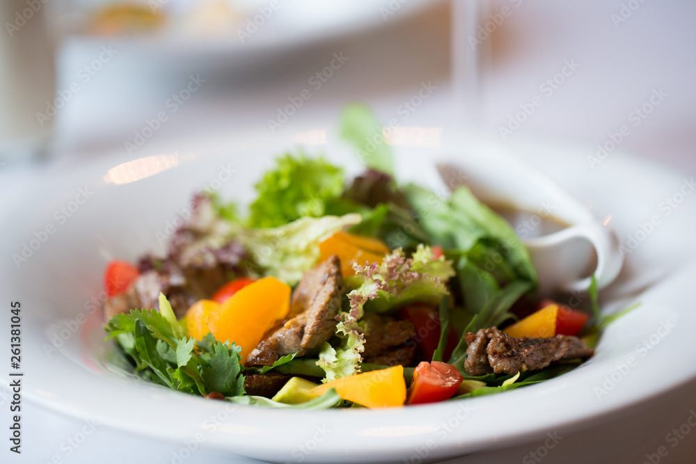 salad with beef, vegetables and sauce. Dinner in restaurant