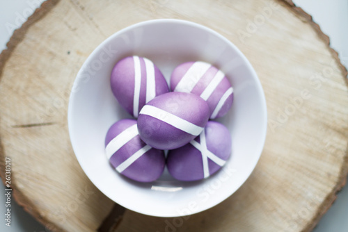 purple Easter egg on a wooden stand