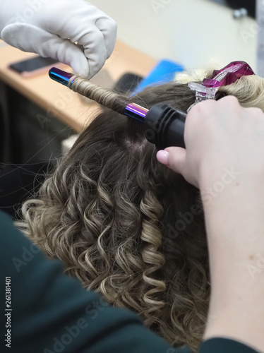 Hair on the Curling iron. Evening hairstyle.