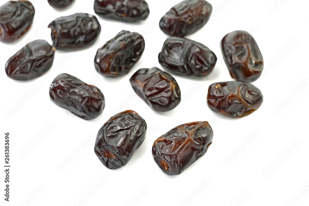Dried dates over white background. Heap of dried dates isolated on white background. Dried dates over white background. Heap of dried dates isolated on white background.