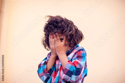Obraz na płótnie Closeup portrait shy little kid with curly hair