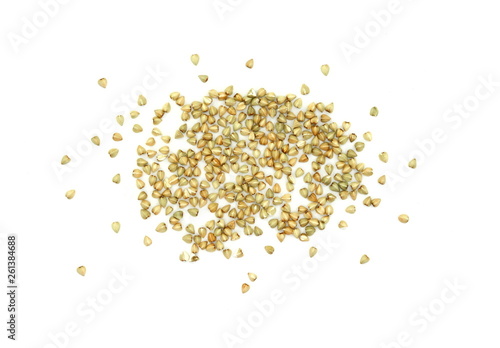 Pile of buckwheat grain isolated on white background close up. Ancooked buckwheat.