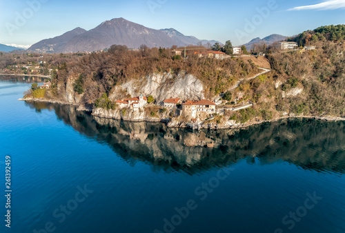 Aerial view of Hermitage of Santa Caterina del Sasso, clinging to a rock face directly overhanging the lake Maggiore, Leggiuno, Italy