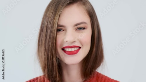 Closeup face of a sexy caucasian girl sending a kiss. Portrait of a beautiful young woman with a sexy pouting lips. Stunning girl is flirting.  Sensual fashion model.