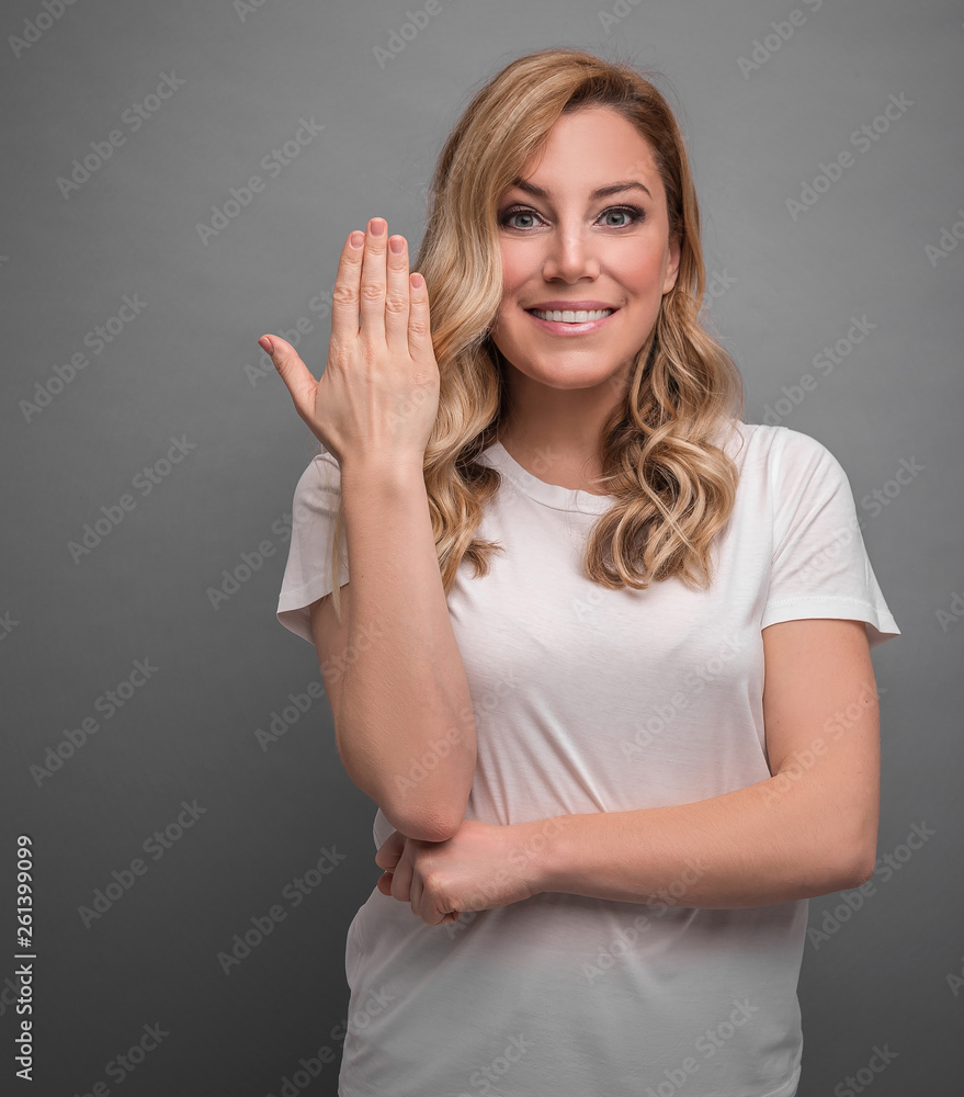 Surprise and misunderstanding on the face of an attractive young woman on gray background. Surprise and misunderstanding on the face of an attractive young woman on gray background.