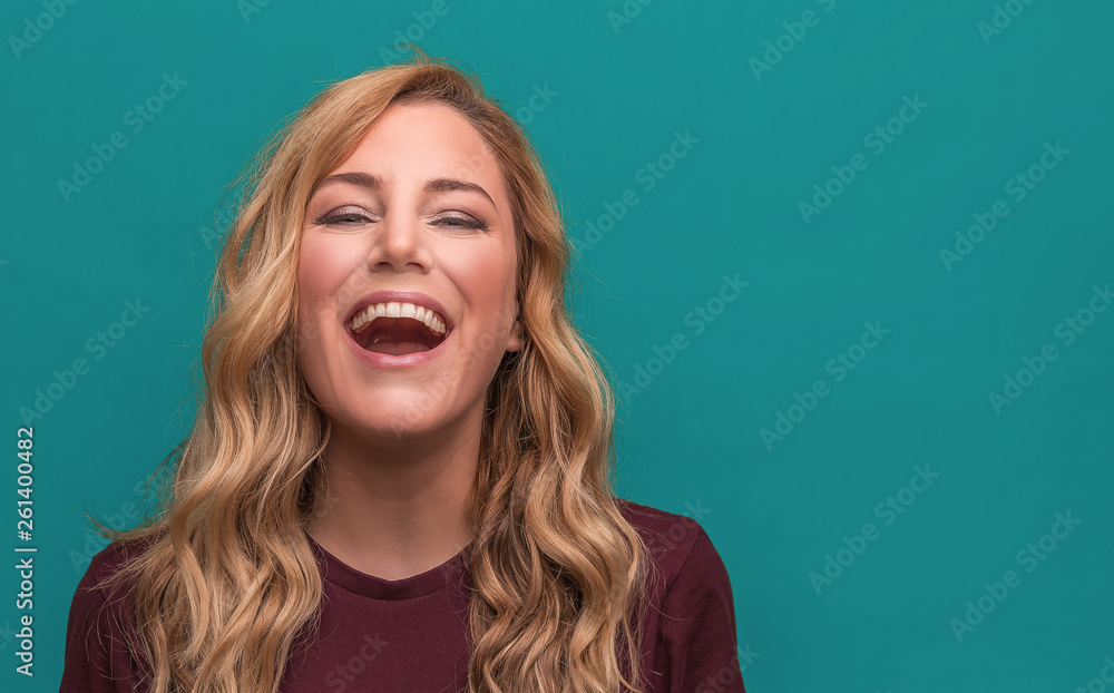 Portrait of a beautiful smiling woman on a blue background. Portrait of a beautiful smiling woman on a blue background.