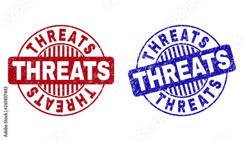 Grunge THREATS round stamp seals isolated on a white background. Round seals with grunge texture in red and blue colors. Vector rubber imprint of THREATS tag inside circle form with stripes.