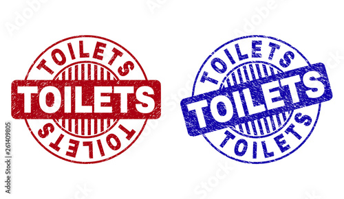 Grunge TOILETS round stamp seals isolated on a white background. Round seals with distress texture in red and blue colors. Vector rubber imitation of TOILETS tag inside circle form with stripes.