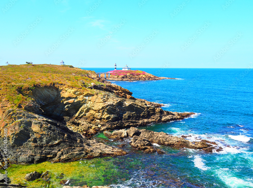 View of the coast and the lighthouse of Illa Pancha in Ribadeo, Lugo, Galicia - Spain
