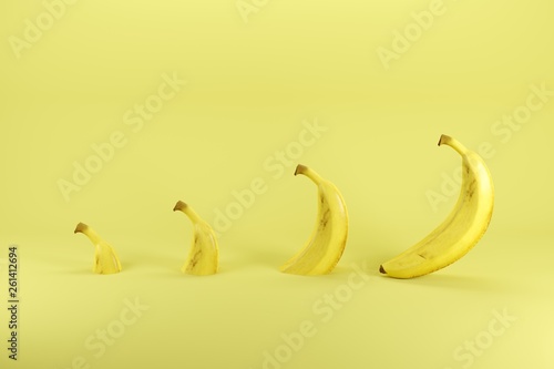 Slices of single ripe banana on pastel yellow background. Minimal fruit idea concept.