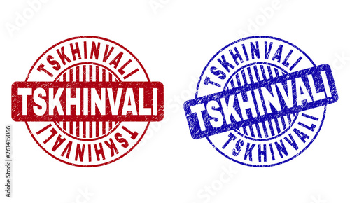 Grunge TSKHINVALI round stamp seals isolated on a white background. Round seals with grunge texture in red and blue colors. Vector rubber imprint of TSKHINVALI label inside circle form with stripes.