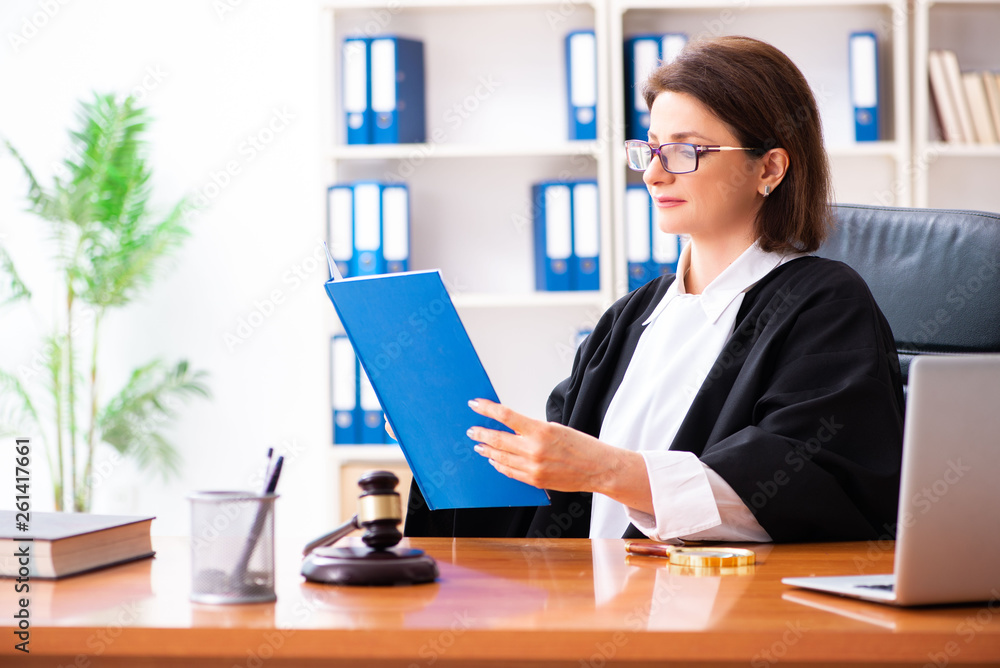 Middle-aged female doctor working in courthouse Middle-aged female doctor working in courthouse
