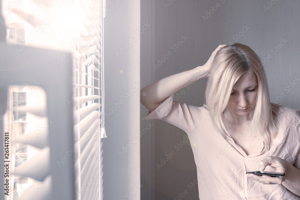 Business woman standing near the wall and using smartphone Business woman standing near the wall and using smartphone
