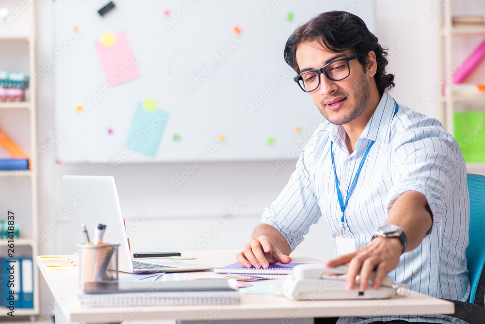 Young handsome male designer working in the office Young handsome male designer working in the office