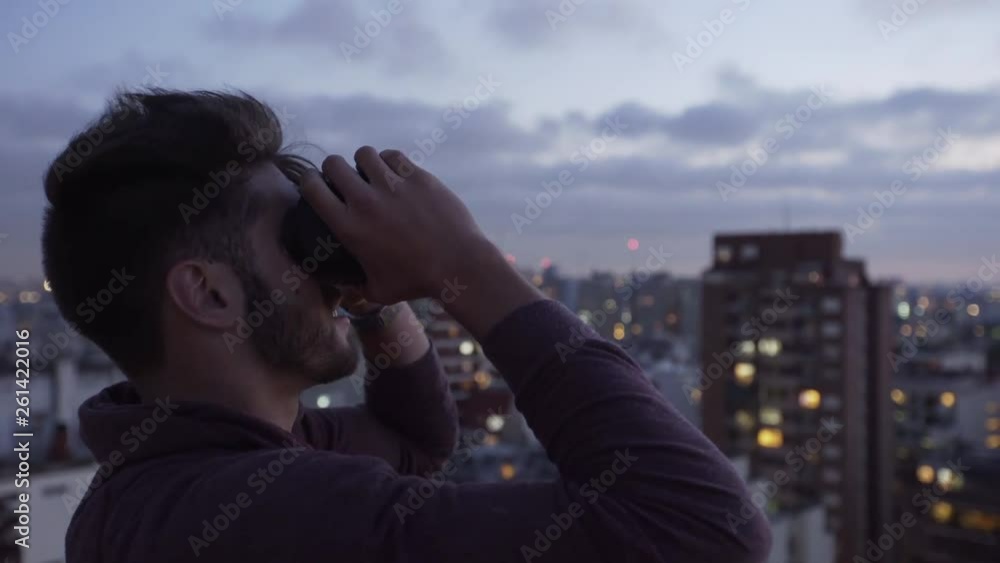 Medium shot of young man wearing virtual reality headset and looking at view Medium shot of young man wearing virtual reality headset and looking at view