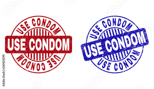 Grunge USE CONDOM round stamp seals isolated on a white background. Round seals with distress texture in red and blue colors.