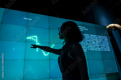 Russia, Vladivostok, July 2018: a girl near an interactive whiteboard in Vladivostok aquarium