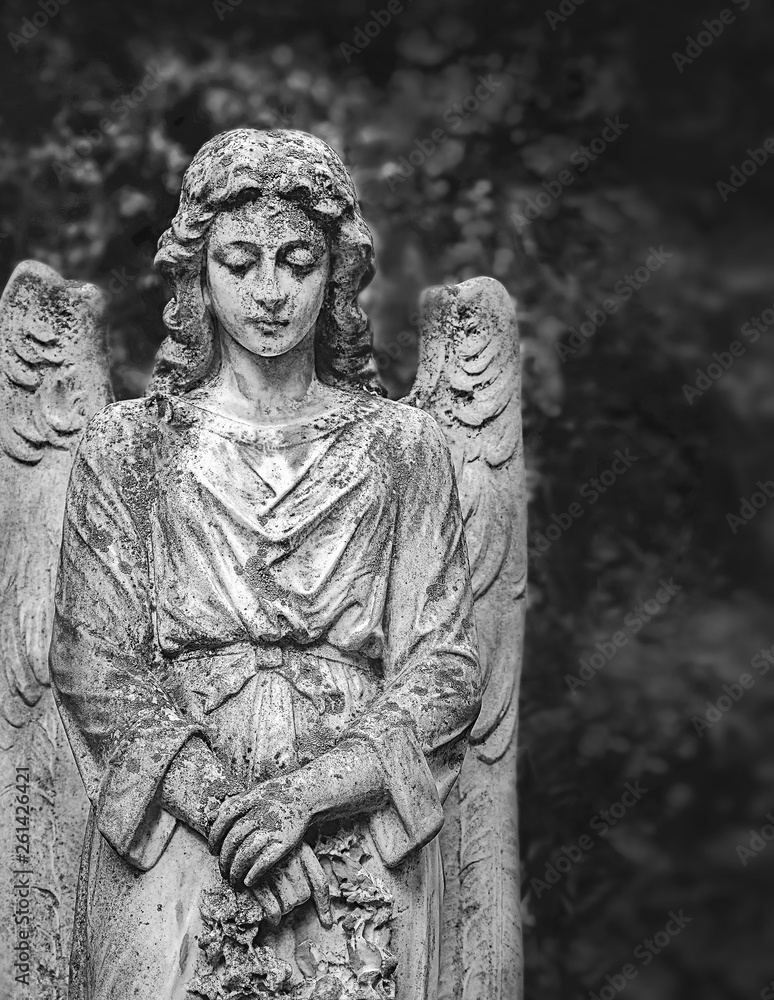 angel statue in cemetery, beautiful tombstone. sad angel. concept of