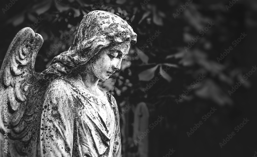 angel statue in cemetery, beautiful tombstone. sad angel. concept of