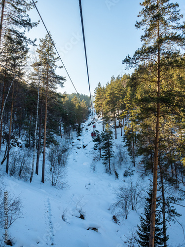 Ropeway to mountain Tserkovka in the resort of Belokurikha in the winter forest, Russia photo