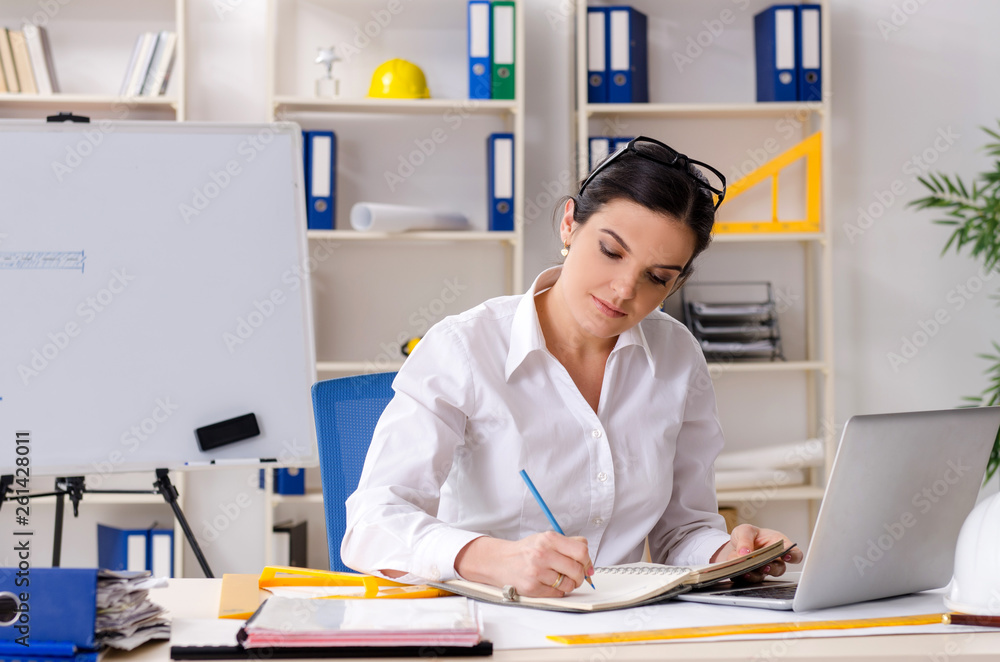 Female architect working in the office Female architect working in the office