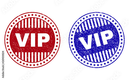 Grunge VIP round stamp seals isolated on a white background. Round seals with grunge texture in red and blue colors. Vector rubber imitation of VIP title inside circle form with stripes.