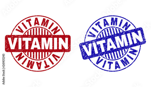 Grunge VITAMIN round stamp seals isolated on a white background. Round seals with grunge texture in red and blue colors. Vector rubber watermark of VITAMIN text inside circle form with stripes.