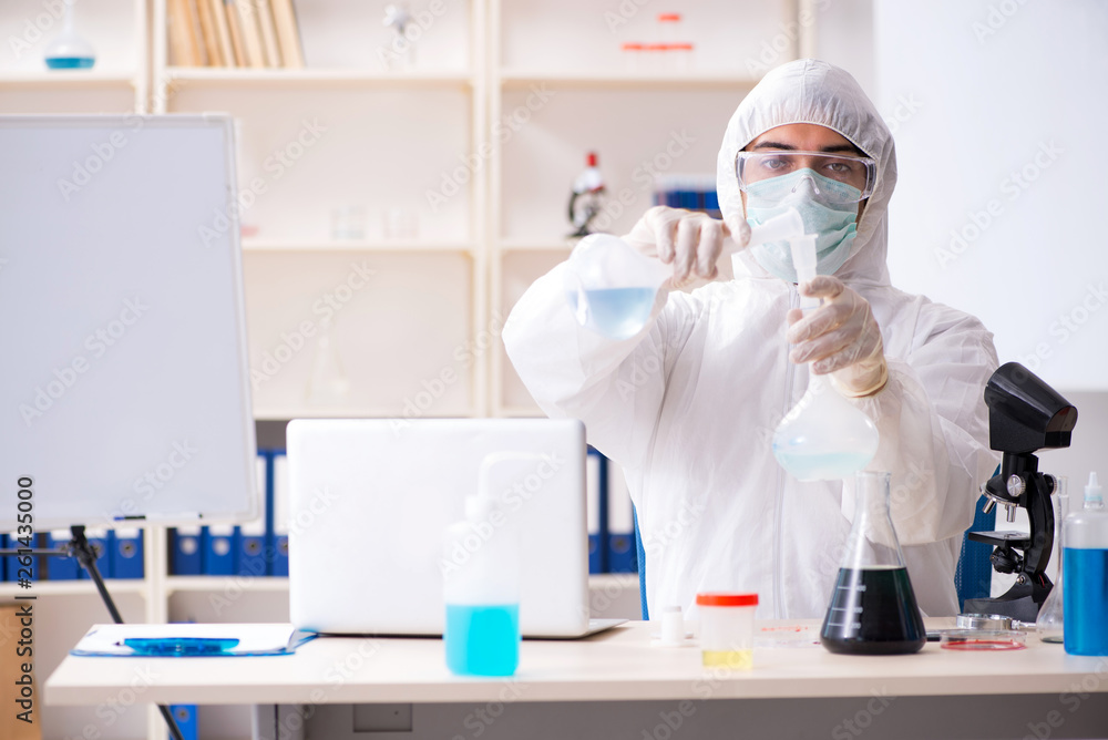 Young handsome chemist working in the lab Young handsome chemist working in the lab