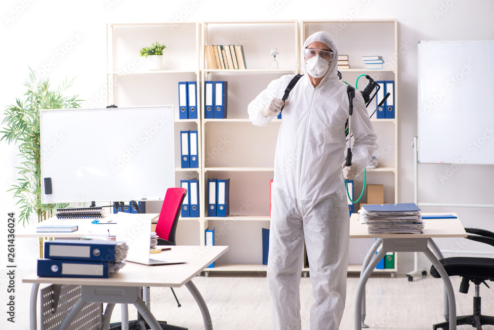 Professional contractor doing pest control at office Professional contractor doing pest control at office